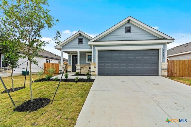 view of front of house featuring a garage, a porch, and a front yard