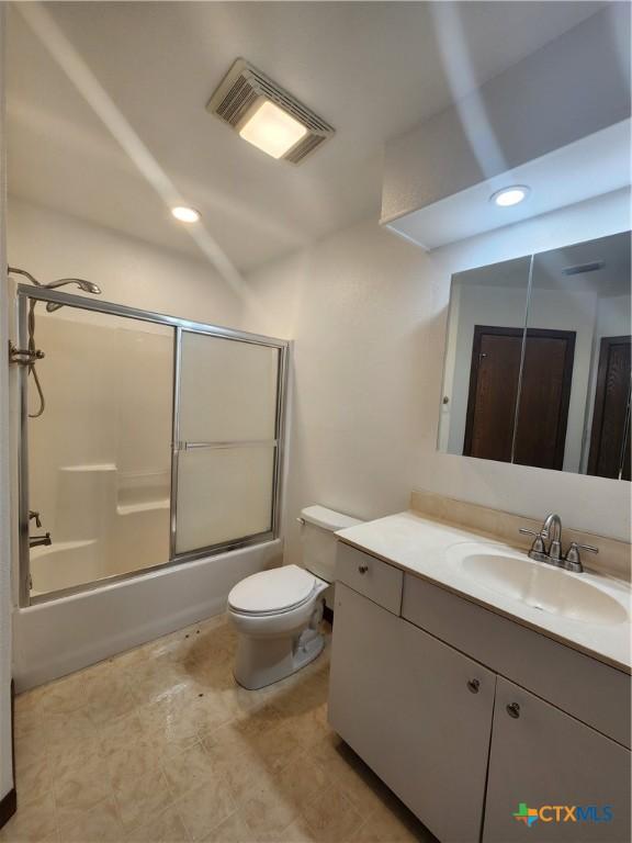 full bathroom with toilet, vanity, and combined bath / shower with glass door