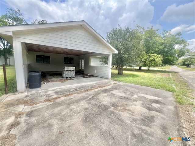 view of property exterior featuring a yard and a carport