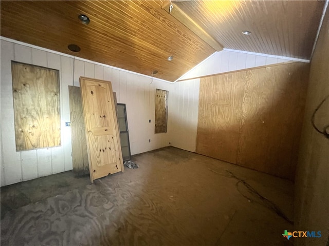 interior space featuring wood walls, vaulted ceiling, and wooden ceiling