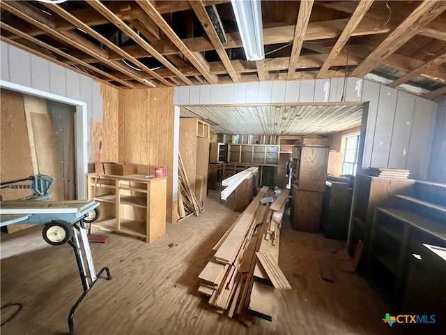 miscellaneous room featuring wood walls