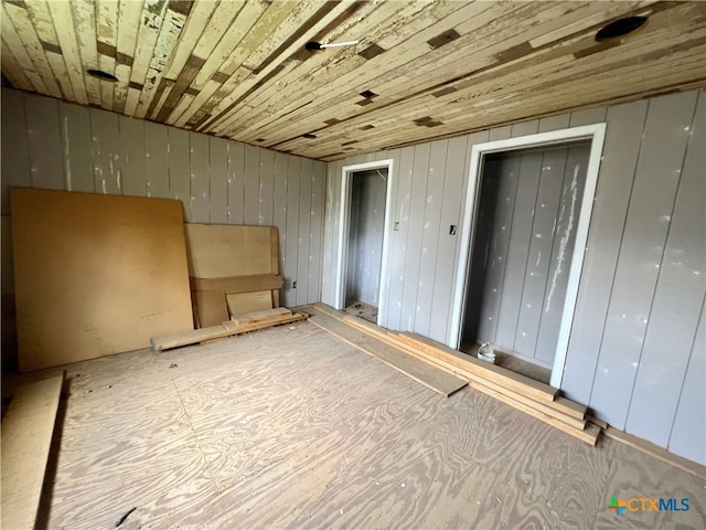 interior space featuring wood walls