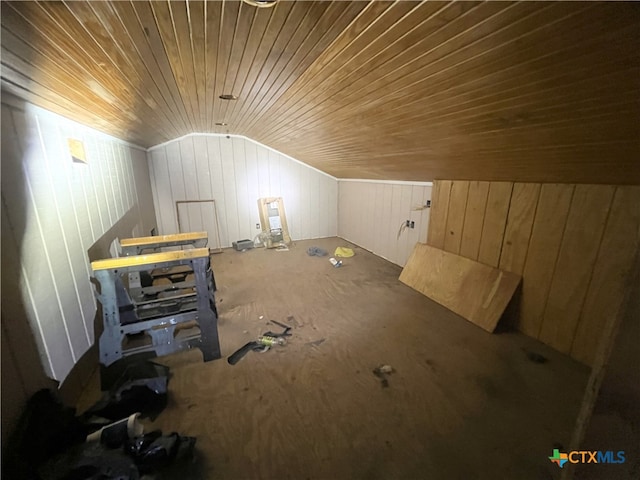 bonus room with wooden ceiling, wooden walls, and lofted ceiling