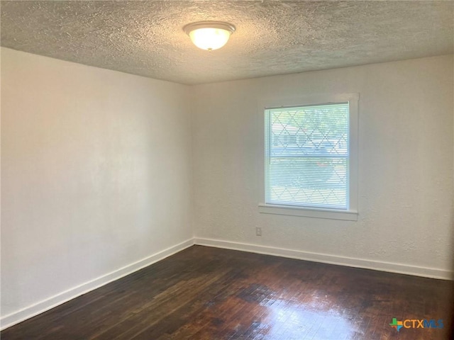 708 E Loma Vista Ave, Victoria, TX 77901 - unfurnished room featuring dark wood-type flooring and a textured ceiling