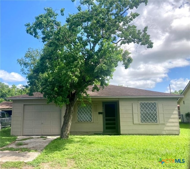 708 E Loma Vista Ave, Victoria, TX 77901 - view of front of home featuring a front lawn, an attached garage, and driveway