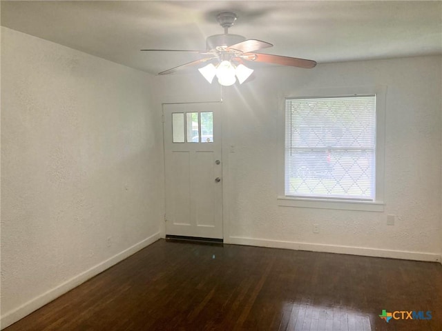 708 E Loma Vista Ave, Victoria, TX 77901 - empty room with dark wood finished floors, a ceiling fan, and a textured wall