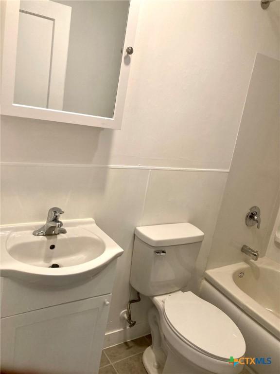 708 E Loma Vista Ave, Victoria, TX 77901 - bathroom with vanity, shower / bathtub combination, and tile patterned flooring