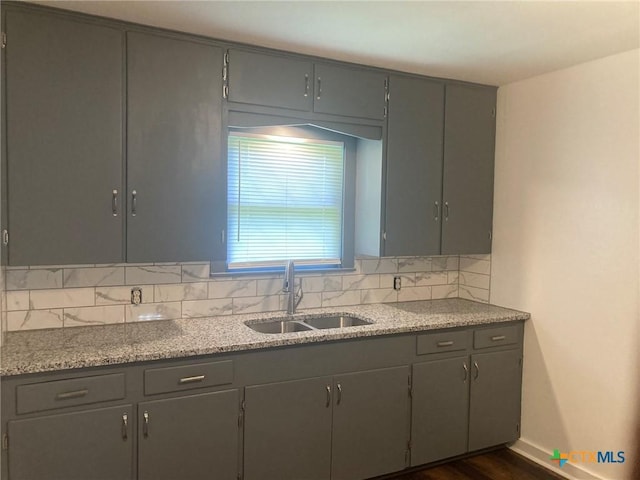 708 E Loma Vista Ave, Victoria, TX 77901 - kitchen with gray cabinets, backsplash, dark wood-type flooring, and light stone countertops