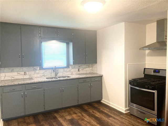 708 E Loma Vista Ave, Victoria, TX 77901 - kitchen featuring stainless steel range with gas cooktop, wall chimney exhaust hood, gray cabinets, dark wood-style flooring, and a textured ceiling