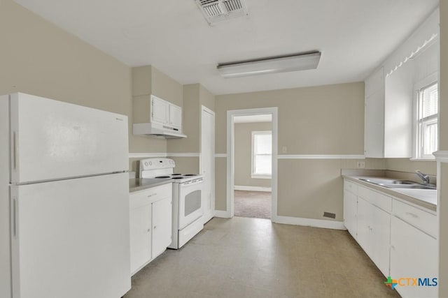 kitchen featuring sink, white appliances, and white cabinets