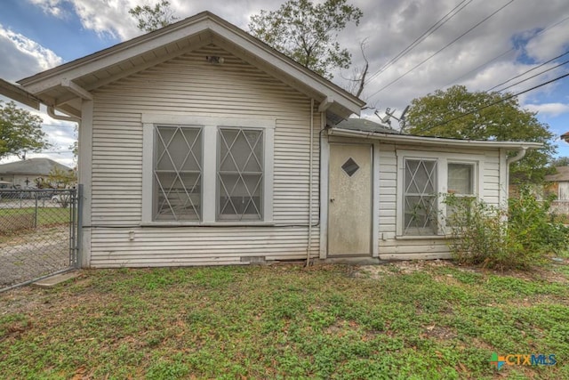 bungalow-style house featuring a front lawn