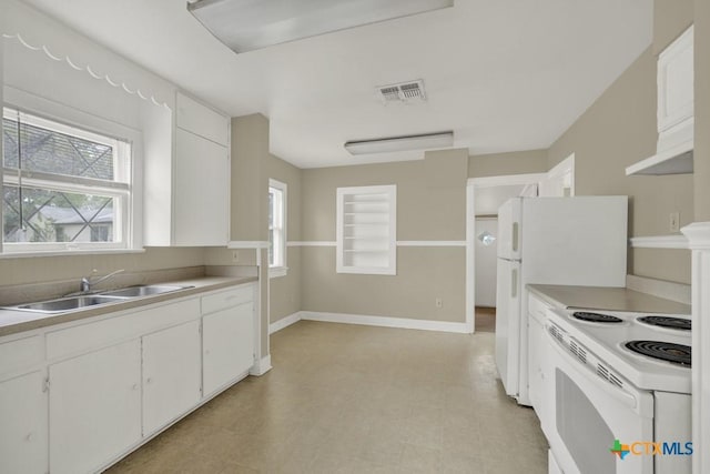 kitchen featuring sink, white appliances, and white cabinets