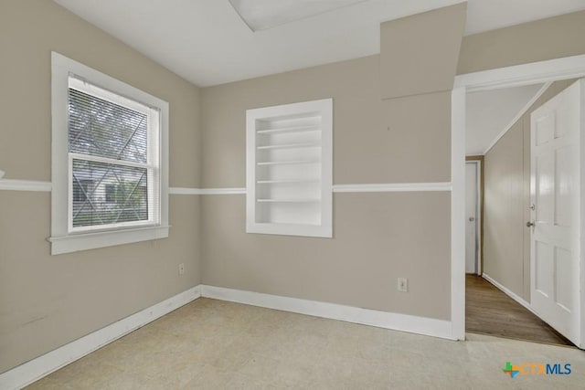 spare room with built in shelves