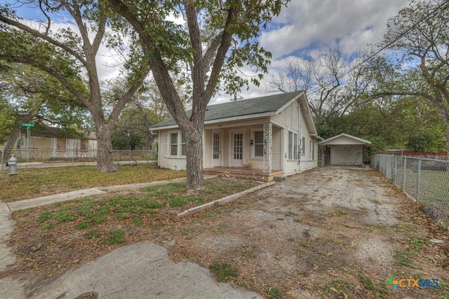 view of front of property with a porch, an outbuilding, and a garage