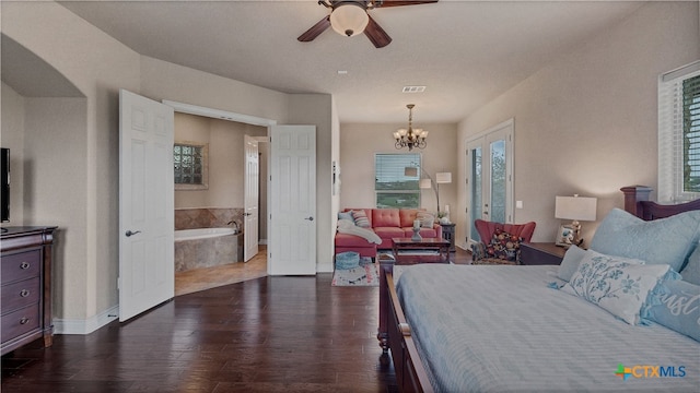 bedroom with ensuite bathroom, ceiling fan with notable chandelier, and dark hardwood / wood-style flooring