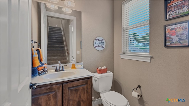 bathroom with toilet and vanity