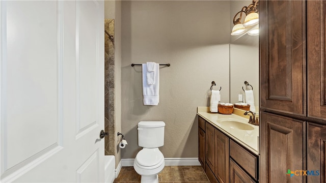 bathroom featuring toilet, vanity, and tile patterned floors