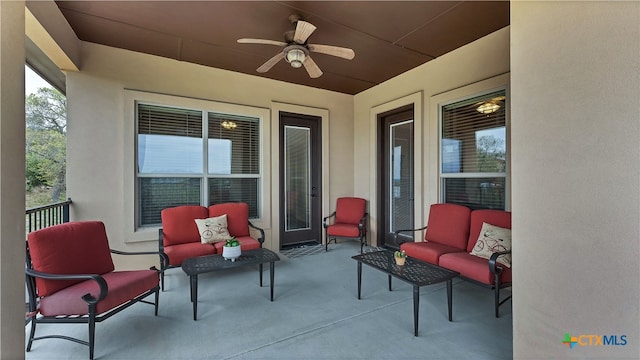 view of patio / terrace with ceiling fan and an outdoor living space