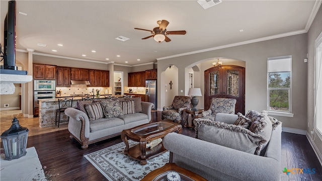 living room with dark wood-type flooring, ceiling fan, and ornamental molding