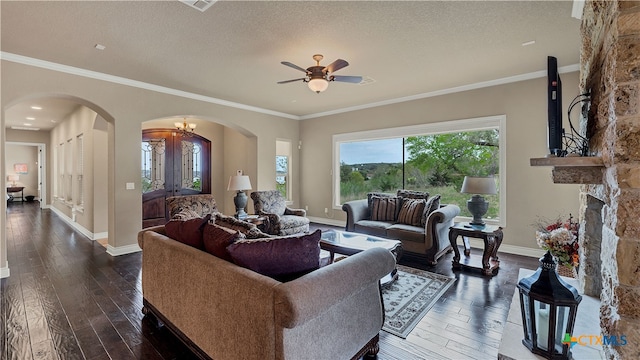 living room with dark wood-type flooring, a textured ceiling, ceiling fan with notable chandelier, and crown molding