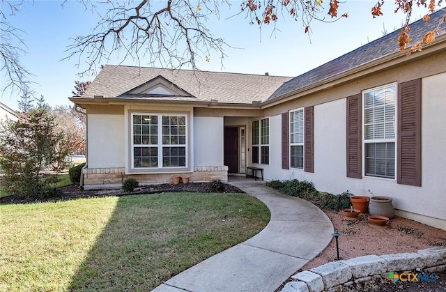 property entrance with a lawn