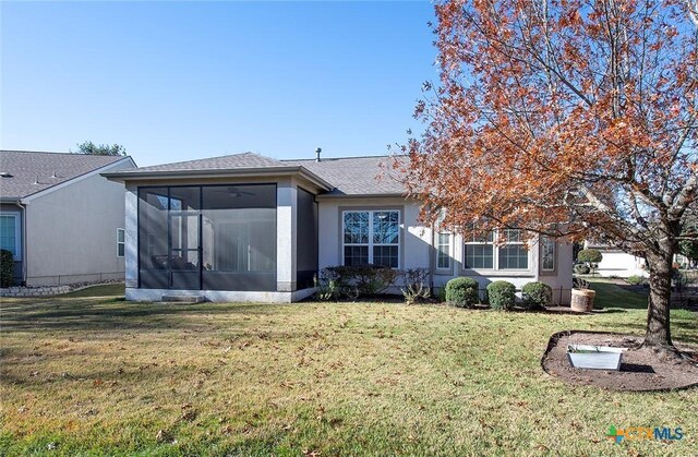 view of front of house with a front lawn and a sunroom