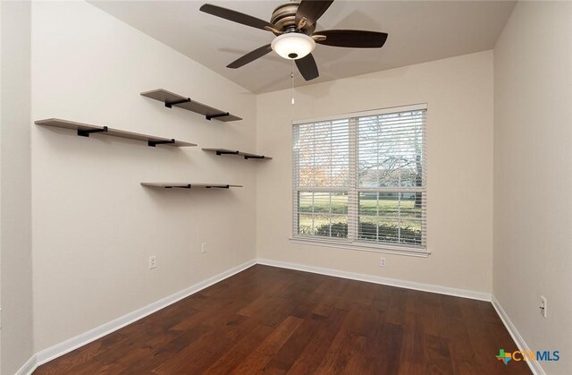 unfurnished room featuring dark hardwood / wood-style floors and ceiling fan