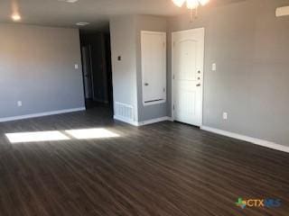 1818 Castroville Trl, Copperas Cove, TX 76522 - spare room with baseboards and dark wood finished floors