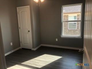 1818 Castroville Trl, Copperas Cove, TX 76522 - spare room featuring wood finished floors, baseboards, and ceiling fan