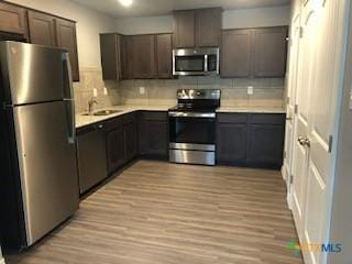 1818 Castroville Trl, Copperas Cove, TX 76522 - kitchen featuring appliances with stainless steel finishes, a sink, decorative backsplash, and light countertops