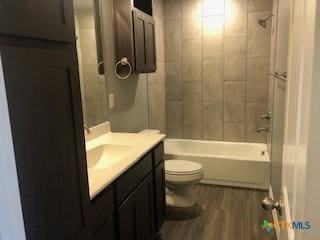 1818 Castroville Trl, Copperas Cove, TX 76522 - full bath featuring vanity, toilet, wood finished floors, and  shower combination