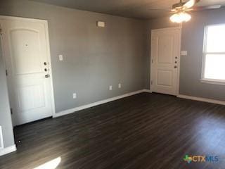 1818 Castroville Trl, Copperas Cove, TX 76522 - unfurnished living room with ceiling fan, baseboards, and dark wood-style floors