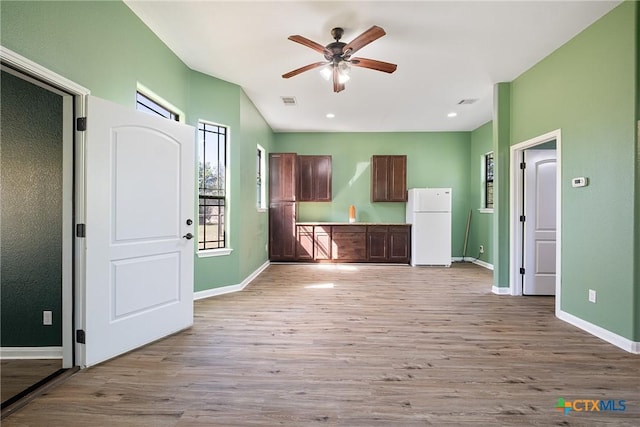 180 Jim Bowie Dr, Paige, TX 78659 - kitchen with freestanding refrigerator, healthy amount of natural light, wood finished floors, a ceiling fan, and recessed lighting
