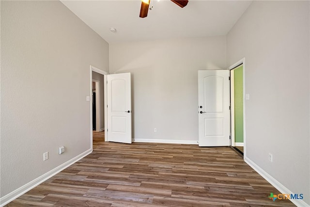 180 Jim Bowie Dr, Paige, TX 78659 - unfurnished bedroom featuring wood finished floors, baseboards, and ceiling fan