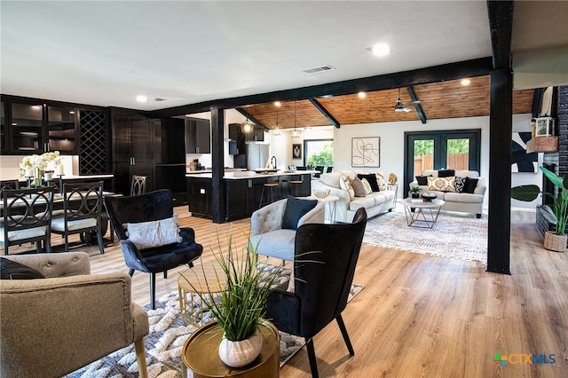 living room featuring wooden ceiling, light hardwood / wood-style floors, sink, ceiling fan, and vaulted ceiling with beams