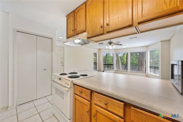 365 S Gilbert Ave, New Braunfels, TX 78130 - kitchen featuring electric stove, under cabinet range hood, light tile patterned floors, ceiling fan, and light countertops
