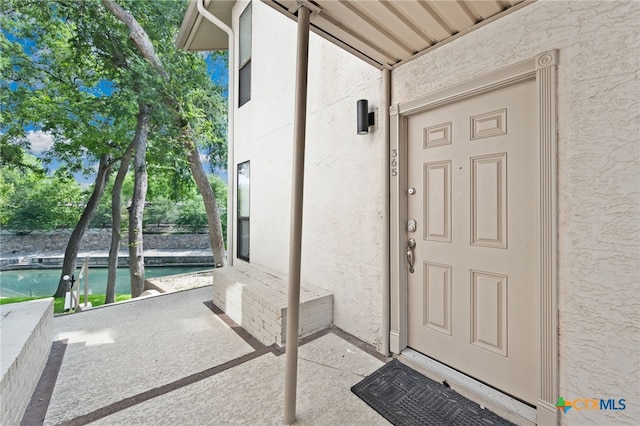 365 S Gilbert Ave, New Braunfels, TX 78130 - doorway to property with stucco siding and an outdoor pool