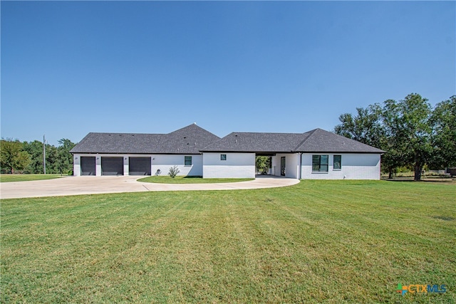 view of front of property with a garage and a front yard