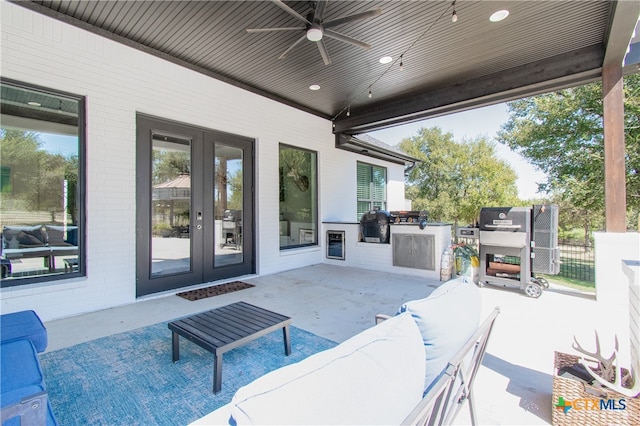 view of patio with an outdoor kitchen, ceiling fan, and french doors