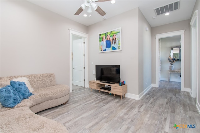 living room featuring wood-type flooring and ceiling fan