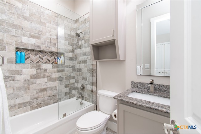 full bathroom featuring toilet, vanity, and enclosed tub / shower combo