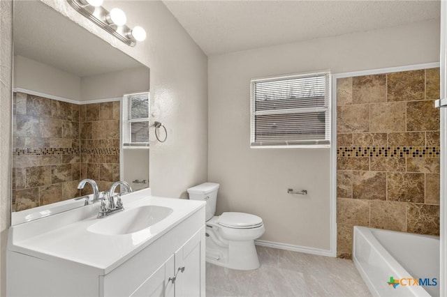 bathroom featuring toilet, vanity, and baseboards