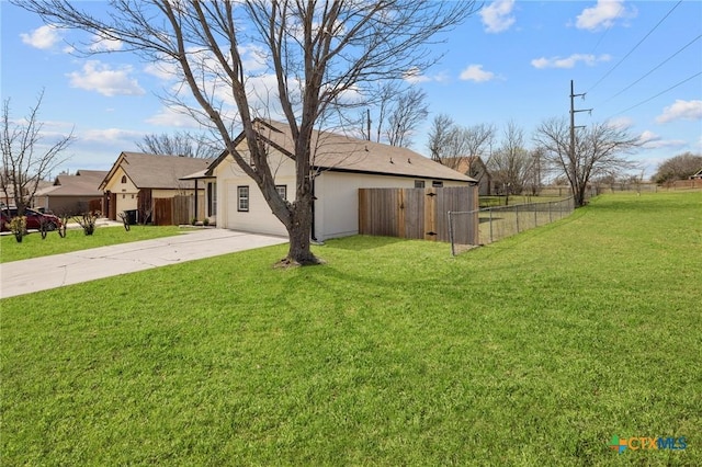 exterior space with a front yard, driveway, and fence