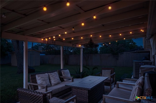 401 Hampshire St, Victoria, TX 77904 - fenced backyard with an outdoor hangout area, a storage shed, and a patio area