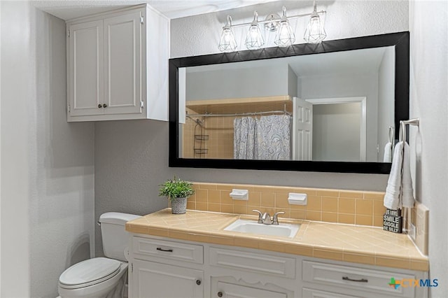 401 Hampshire St, Victoria, TX 77904 - bathroom with vanity, a textured wall, decorative backsplash, and a shower with curtain
