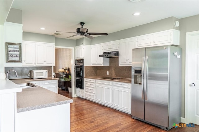 401 Hampshire St, Victoria, TX 77904 - kitchen with black appliances, under cabinet range hood, a ceiling fan, white cabinets, and recessed lighting