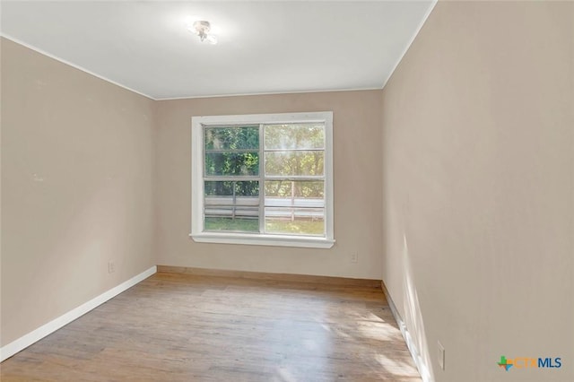 1210 Old Martindale Rd, San Marcos, TX 78666 - empty room with crown molding, baseboards, and wood finished floors