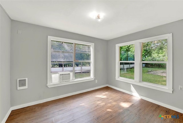 1210 Old Martindale Rd, San Marcos, TX 78666 - unfurnished room featuring baseboards, cooling unit, and wood finished floors