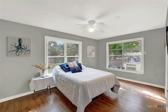 1210 Old Martindale Rd, San Marcos, TX 78666 - bedroom with baseboards, multiple windows, and wood finished floors