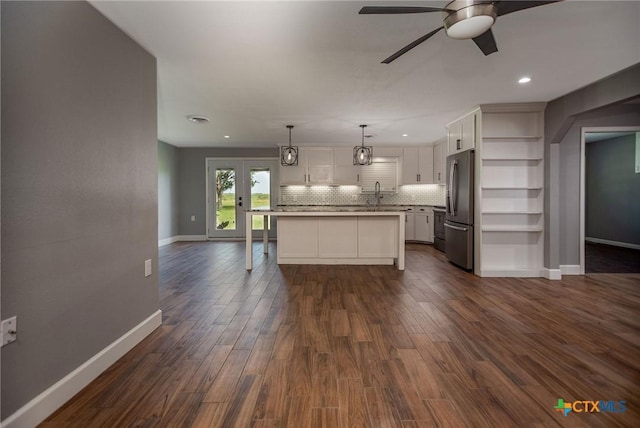 248 Park Rd, Port Lavaca, TX 77979 - kitchen featuring freestanding refrigerator, ceiling fan, baseboards, white cabinets, and light countertops